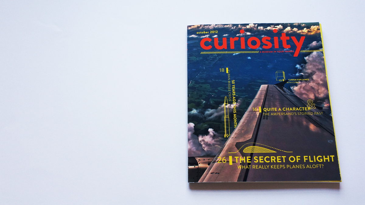 The cover of Curiosity features an aerial view shot by an airplane rider with a window seat just over the wing.